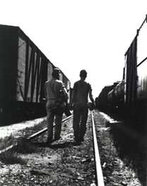 Guys in between trains
Graphic